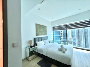 a bedroom with a large bed and a large window at IKON SUITE's E A T O N KLCC in Kuala Lumpur +199 photos