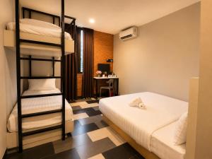 a bedroom with a bunk bed and a desk at the youniQ Hotel, KLIA T1, KLIA T2 in Sepang