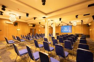 a conference room with chairs and a screen at Grande Candor Exclusive Hotel in Warri Airport +43 photos