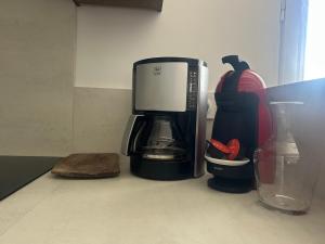 a coffeemaker sitting on a counter next to a coffee maker at Maison Ty Bihan Sioul in Sarzeau