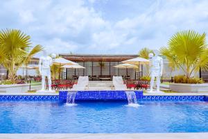 a swimming pool with two statues of men standing around it at Grande Candor Exclusive Hotel in Warri Airport