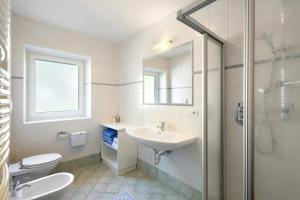 a bathroom with a sink and a toilet and a shower at THALERHOF Onach Dolomites - Kronplatz in San Lorenzo di Sebato +51 photos