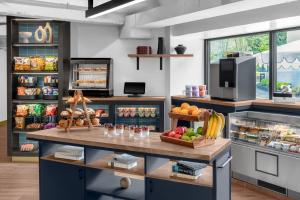 a kitchen with a counter with fruits and vegetables at ARC Hotel, Washington DC, Series by Marriott in Washington, D.C.