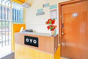 an office entrance with a yeso sign on a counter at Hotel O JK Blue Rock Comforts in Bangalore