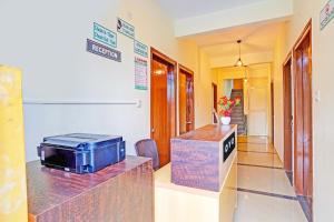 a lobby with a microwave on a counter in a room at Hotel O JK Blue Rock Comforts in Bangalore