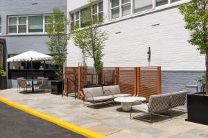 a patio with chairs and tables in front of a building at ARC Hotel, Washington DC, Series by Marriott in Washington, D.C.