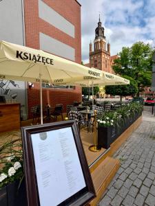 a sign in front of a restaurant with a menu at Hotel Grodzki Business & Spa in Stargard