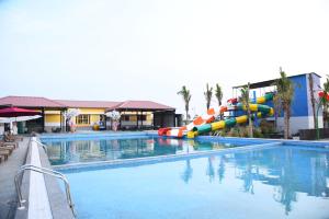 a large swimming pool with a water slide at Chitra's City Side Resort in Solapur