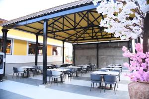 a group of tables and chairs under a pavilion at Chitra's City Side Resort in Solapur