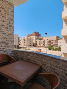 a table and chairs on a balcony with a view of a city at See you soon blue Beach in Marsa Matruh