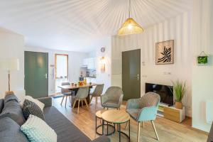 a living room with a couch and a table at Les Charmes C15 - Le Val Joly in Eppe-Sauvage