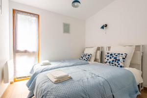 a bedroom with two beds and a window at Les Charmes C15 - Le Val Joly in Eppe-Sauvage