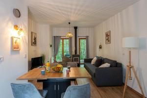 a living room with a couch and a table at Les Charmes C15 - Le Val Joly in Eppe-Sauvage