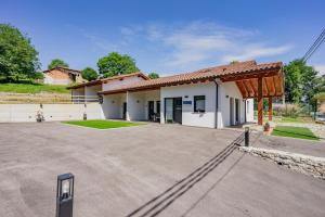 a building with a large parking lot in front of it at Apartamentos el Caneyón in San Juan de Parres