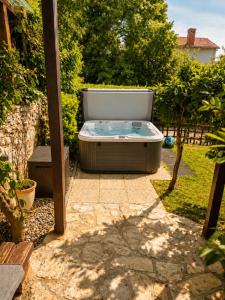 a hot tub sitting in the middle of a yard at Family nest Medulin- apartment with private parking and jacuzzi in Medulin