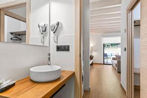 a bathroom with a white sink on a counter at Apartamentos el Caneyón in San Juan de Parres +40 photos
