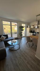 a living room with a couch and a table at Villa Lena mit Fahrstuhl und Bäcker im Haus, direkt an der Flaniermeile in Ostseebad Sellin