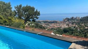 a swimming pool with a view of the city at Villa Azur Horizon in La Turbie