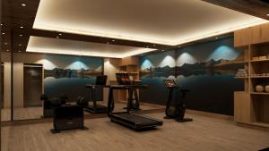 a gym with a wall with a mural of mountains at Hotel Garni Hainbacherhof in Sölden