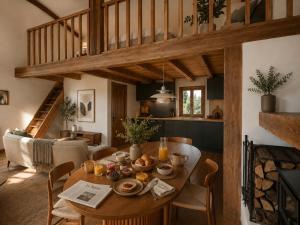 a dining room with a table with food on it at La Cabane de l'autre monde in Chavin