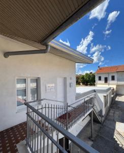 a balcony of a white building with a roof at Hi Malpensa - Apartment in Case Nuove