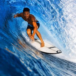 a man riding a wave on a surfboard in the ocean at Jala Villas Lances Right HTs Mentawai in Katiet