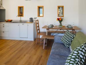 a living room with a couch and a table at Erddyn - Uk48860 in Llanddwywe