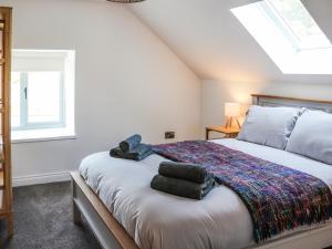 a bedroom with a bed and a window at Erddyn - Uk48860 in Llanddwywe +11 photos