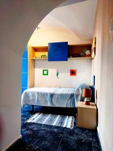 a bedroom with a bed and a blue and white wall at La Perla de Montánchez in Montánchez +31 photos