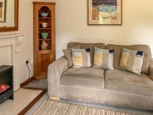 a living room with a couch and a fireplace at The Lodge in Uny Lelant