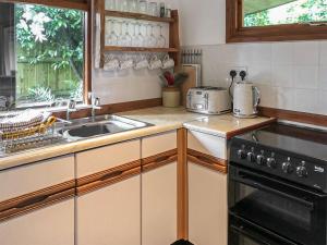 a kitchen with a sink and a stove at The Lodge in Uny Lelant +9 photos