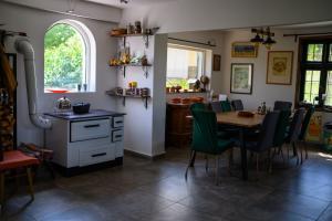 a kitchen and dining room with a table and chairs at Kuća Sokolovića in Zaječar