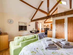 a living room with a bed and a couch at The Dairy - Uk10957 in Burlton