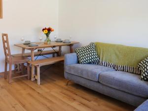 a living room with a couch and a table at Bodlyn - Uk48861 in Llanddwywe