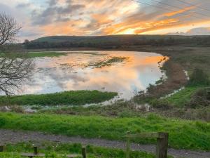 a view of a body of water at sunset at Lodge With A View in Steyning