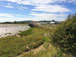 a bridge over a body of water with a fence at Lodge With A View in Steyning +10 photos