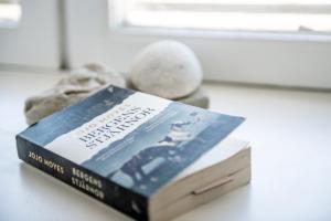 a book sitting on a table next to some rocks at STF Visby Hamn Vandrarhem in Visby