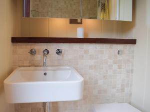 a bathroom with a sink and a toilet at The Wooden Lodge in Byton +8 photos