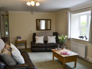 a living room with a couch and a coffee table at The Gin Gan Cottage in Ryal