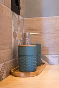 a close up of a toothbrush holder in a bathroom at B&B Anima Selvaggia Ranch in Castellero +29 photos