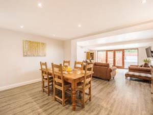 a dining room and living room with a table and chairs at Stuarts Farm Barn in Westhead