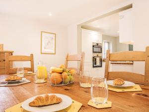 a table with plates of bread and a basket of fruit at Stuarts Farm Barn in Westhead +20 photos