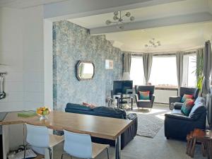 a living room with a table and chairs at Lloyds Cottage in Southwell