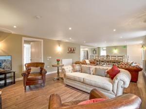 a living room with two couches and a couch and chairs at Potarch Lodge in Kincardine OʼNeil