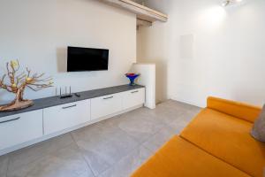 a living room with a couch and a flat screen tv at Predore Lake View Suites in Predore