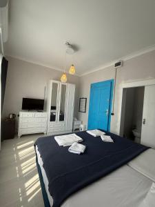 a bedroom with a bed with two towels on it at Olivento Pansiyon in Ayvalık