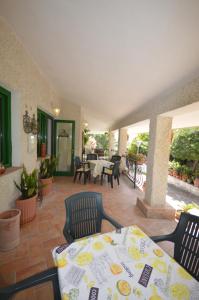 a patio with a table and chairs on a patio at La Lomita in Santa Marinella +49 photos