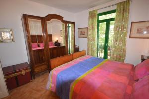 a bedroom with a colorful bed and a mirror at La Lomita in Santa Marinella