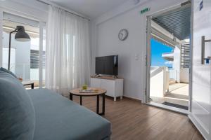 a living room with a couch and a table at SLV Roxani Apartment in Ofrínion