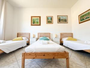 a room with three beds in a room at Cuore di Nozzano Castello in Lucca